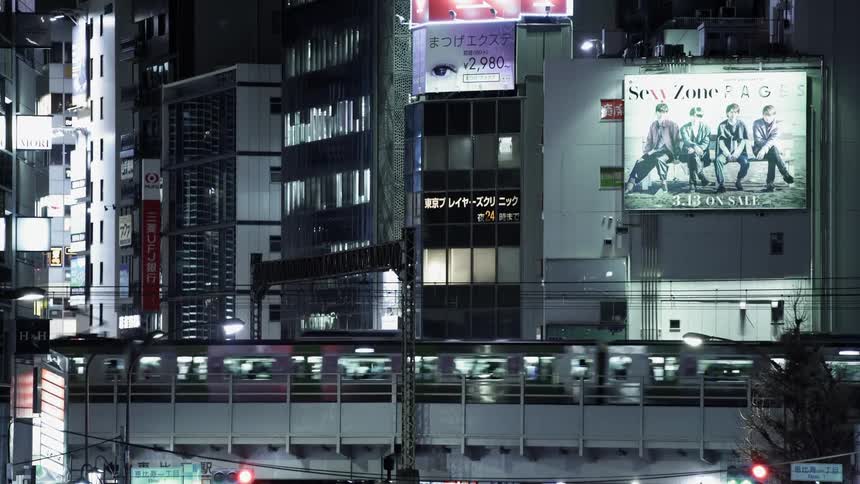 Subway travels past buildings at night