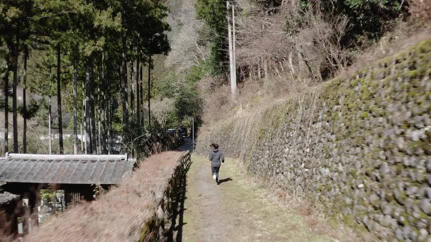 Woman jogs in a forest