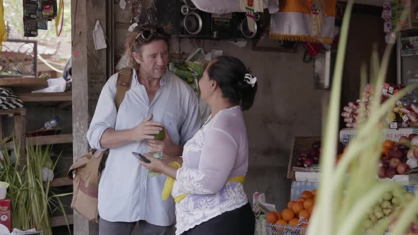 Man gives a woman some money at a market