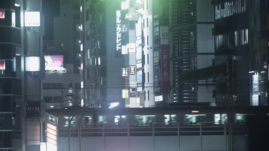 A subway train crosses a city bridge at night