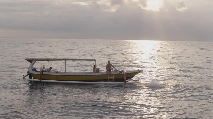 A man dives off a boat into the water