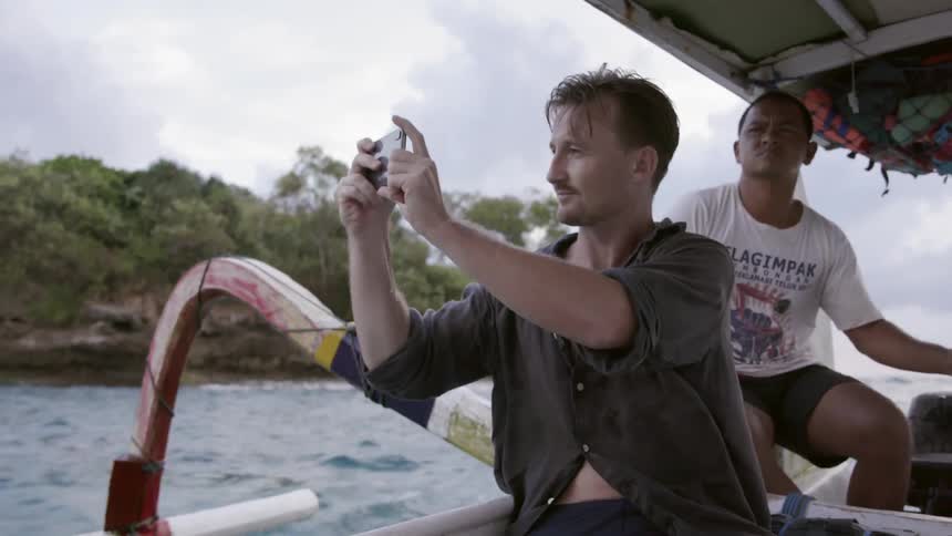 Two men riding in a boat in afternoon