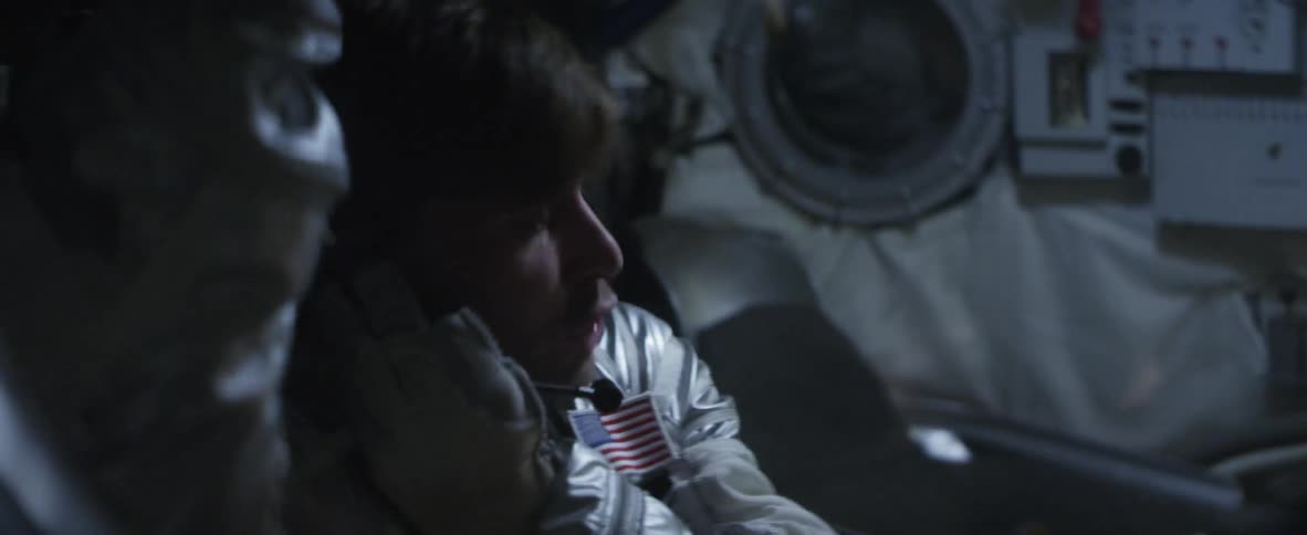An astronaut pants and talks on his headset before the space ship starts to shake and vibrate