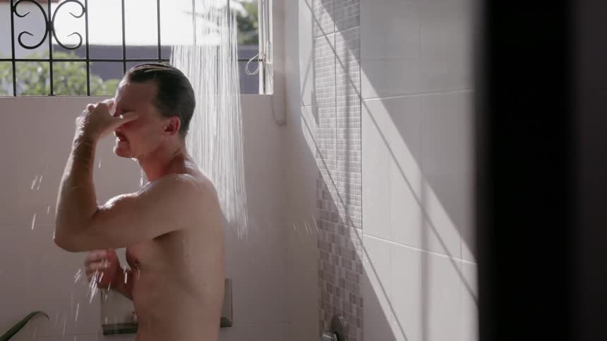 A man is taking a shower in his home