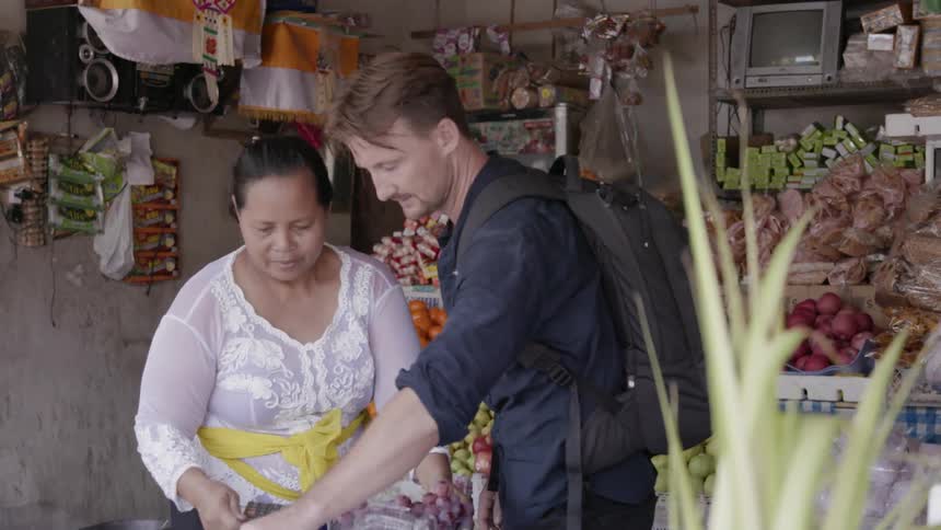A man shops for produce in a market