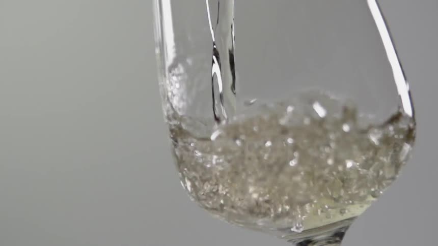 White wine is poured into a wine glass