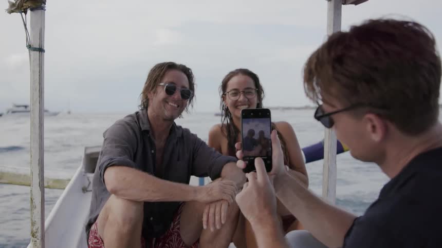 Friends take a photo on a small boat