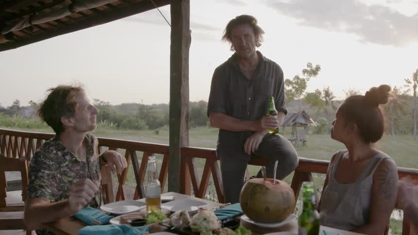 A group of people drink together outside