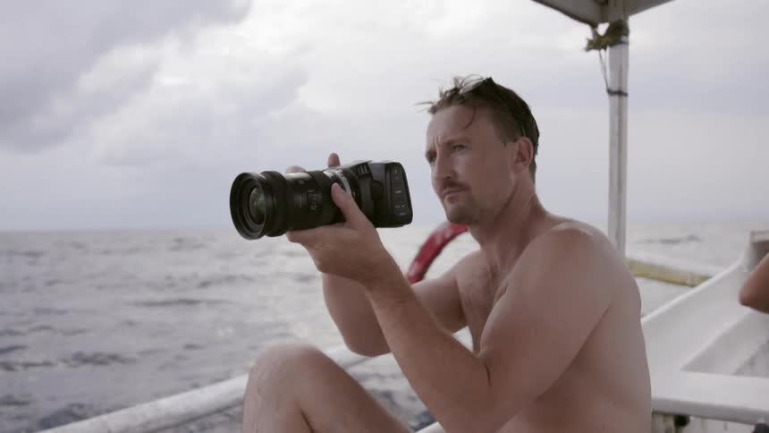 Man takes a photograph on a boat