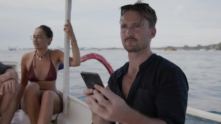 Man takes a photo on a boat