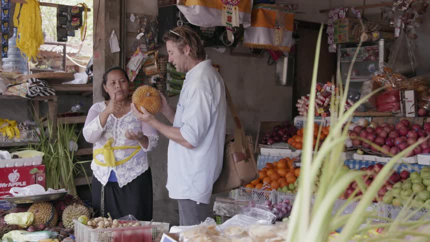 A man looks at produce in a market