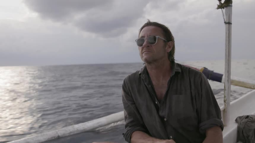 A man rides on a boat in the water