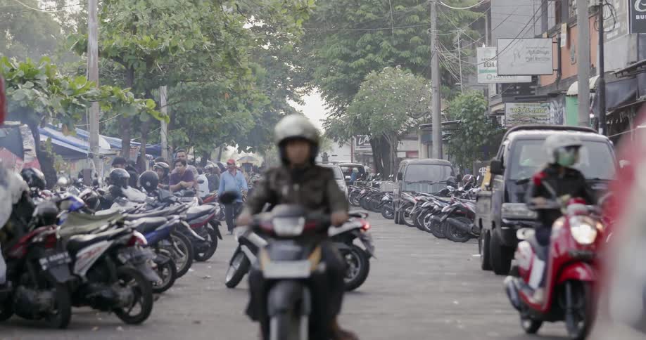 Motorcyclists ride on a city road