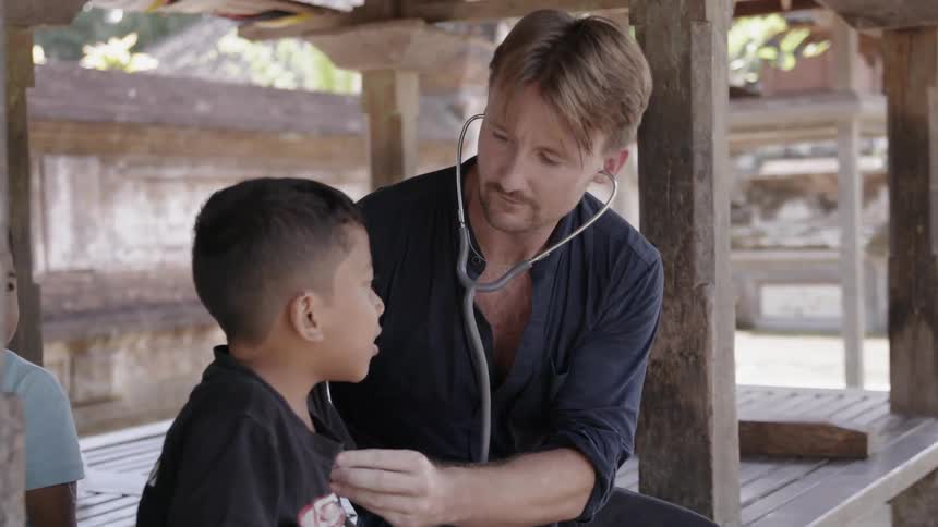 Man listens to a child's heart with a stethoscope