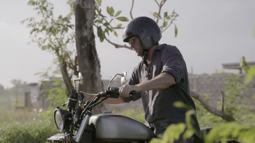 Motorcyclist rides on a rural road