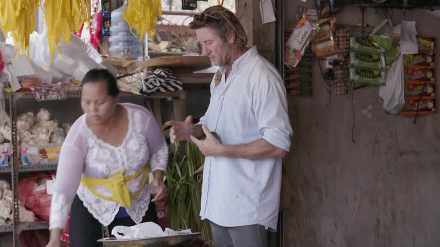 A man shops for produce at a market