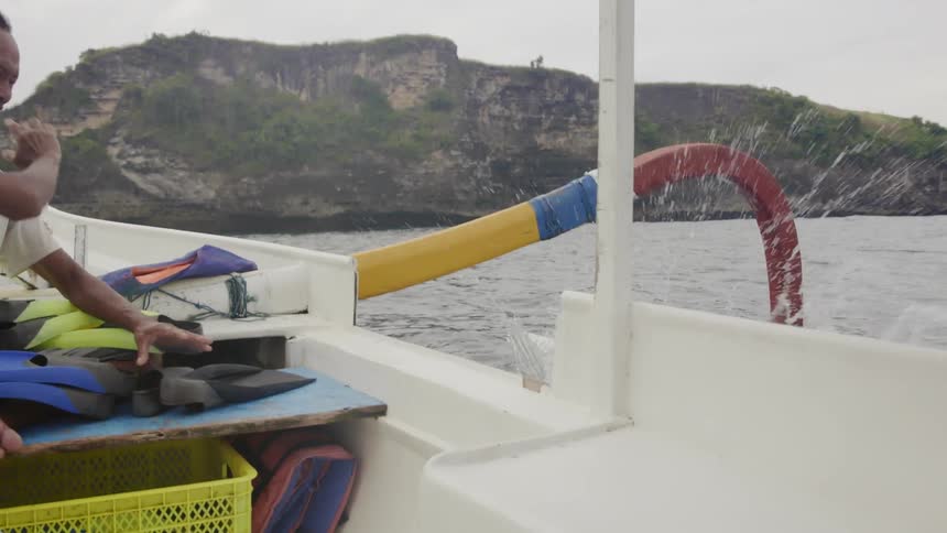 A man dives into the water from a boat