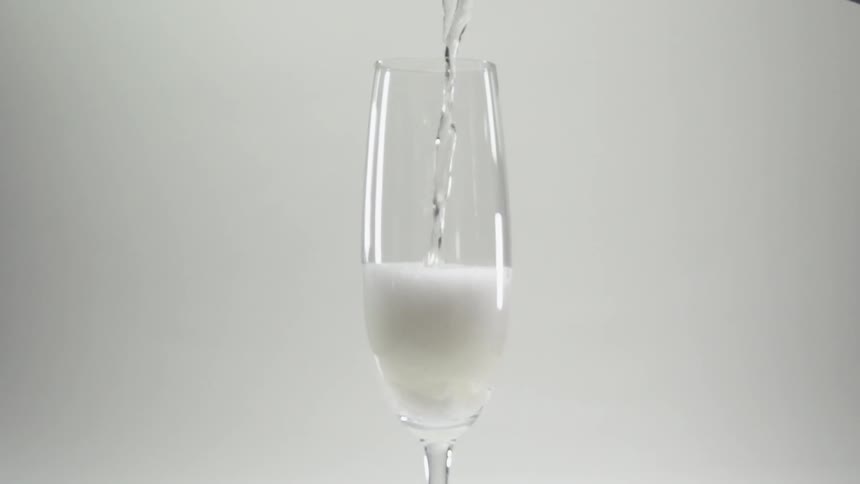 A beverage is poured into a wine glass