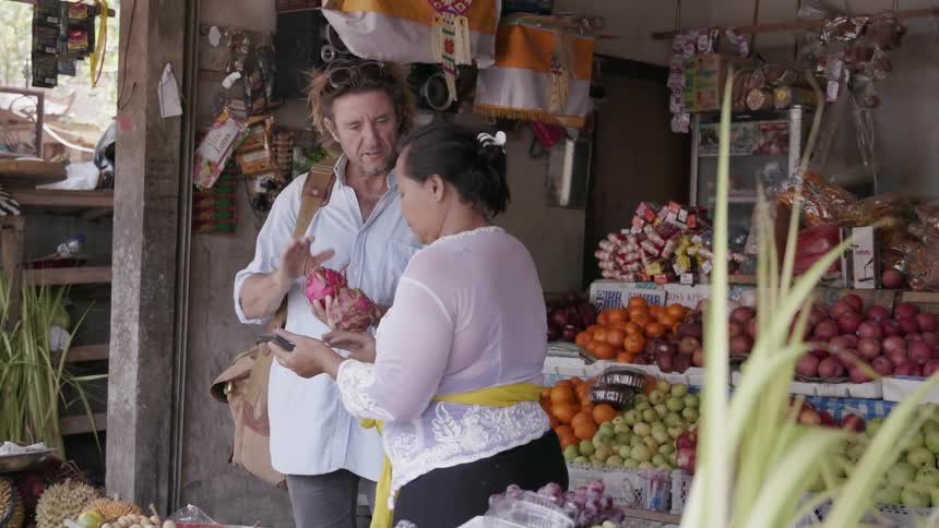 A man shops for produce at a market