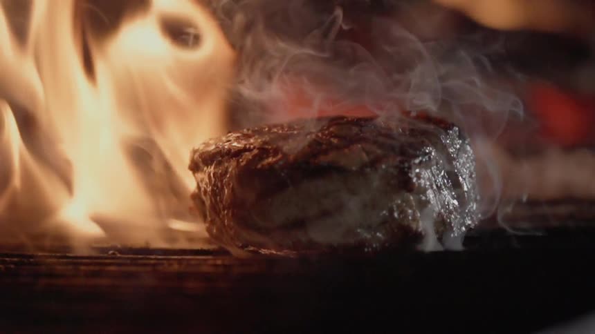 A steak is cooked on the grill