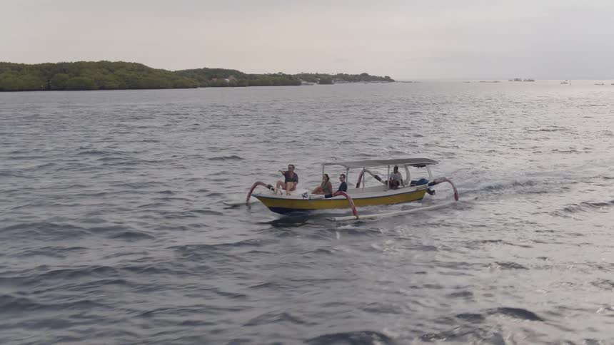 People ride on a boat on the ocean