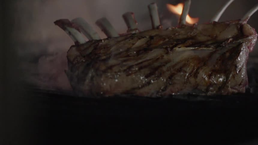 Rack of ribs sizzle on a grill