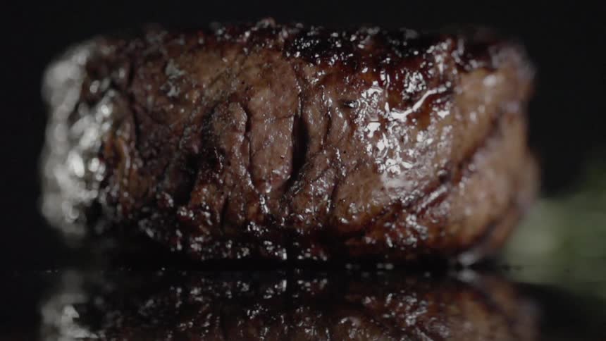 A piece of cooked meat is dropped on the counter