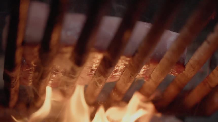 A steak is cooked on a grill