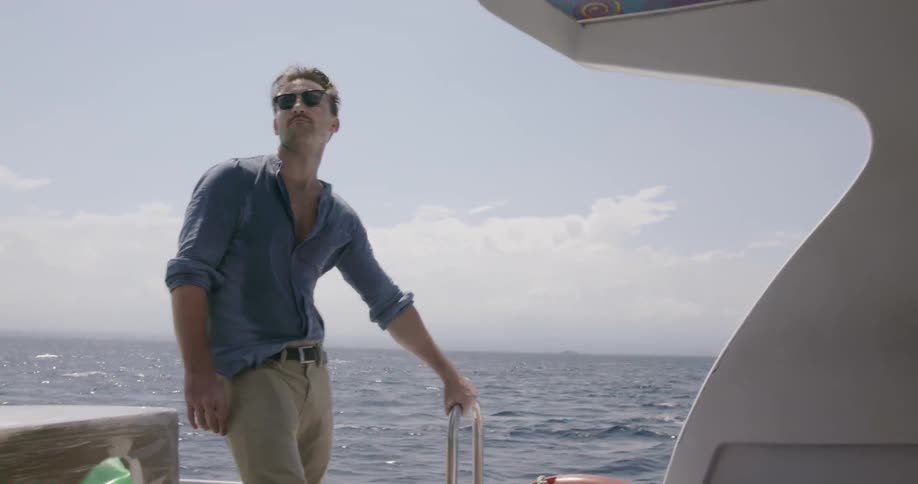 A man rides on the back of a boat