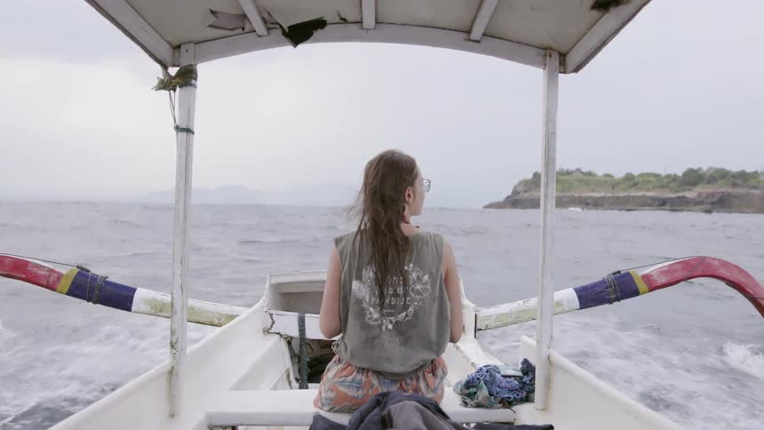 A woman rides on the boat