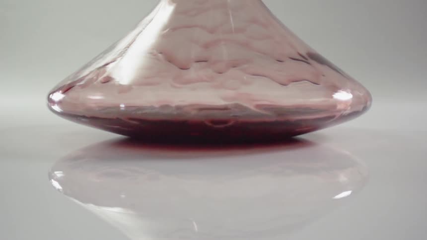 Liquid pours slowly into a beaker
