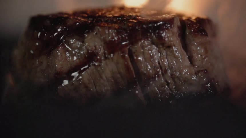 A steak is cooked on a grill