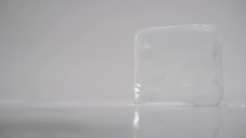 An ice cube spins on a surface