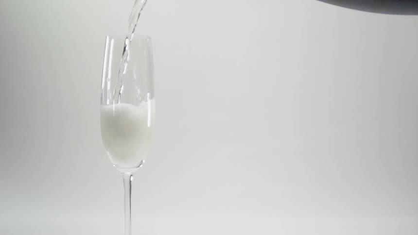 Champagne is poured into a glass
