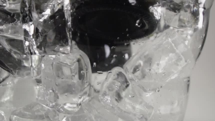 A bottle is pulled from a bowl of ice