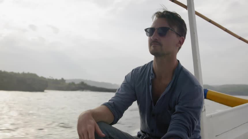 A man rides on a boat in the water