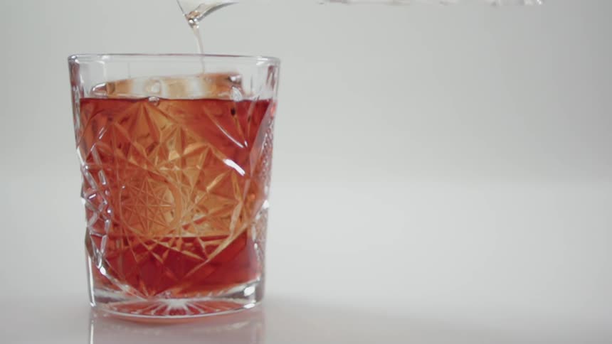 A drink is poured into a glass