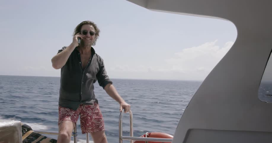 Man talks on the phone on a boat