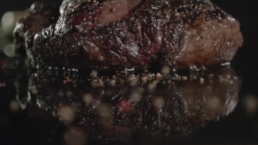 Seasoning is added to a cooked steak