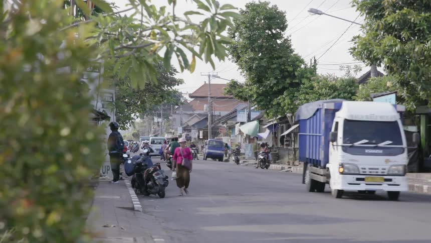 Commuters travel on a city street