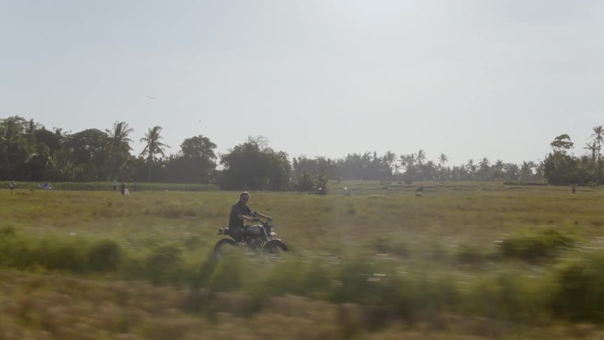 Man rides a motorcycle in the country