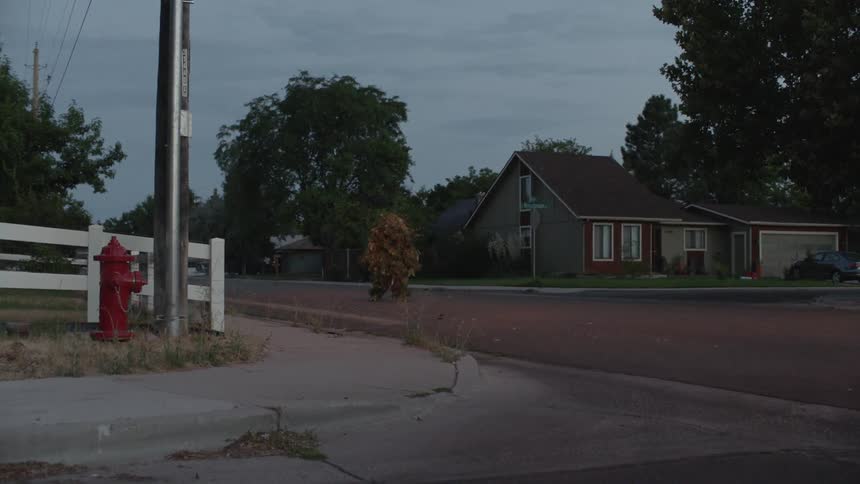 A person wearing heavy camouflage outfit walks down the street