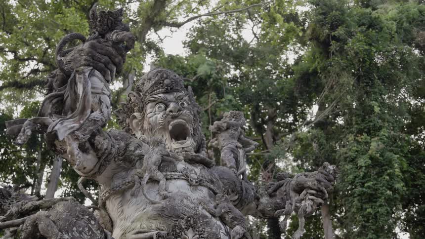 A statue is surrounded by trees