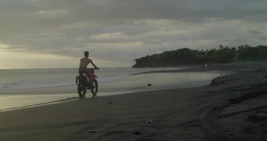 Man riding a bike on the beach