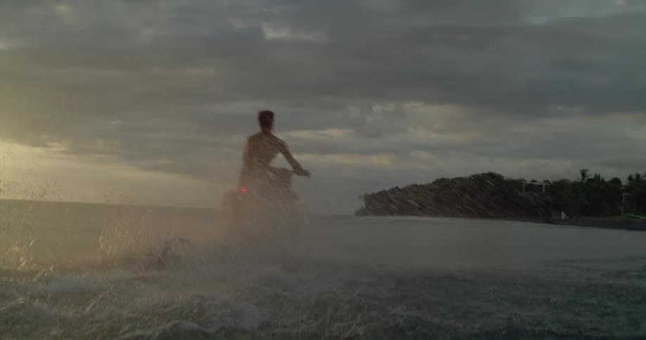 A man rides on the beach in a motorcycle
