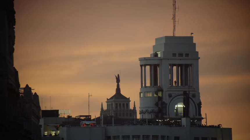 Light shines from a building at sunset
