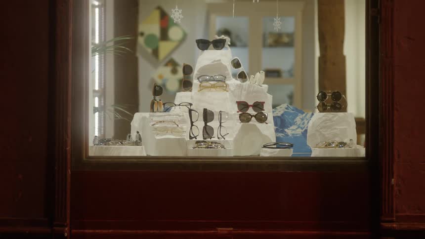 Sunglasses are displayed in a storefront