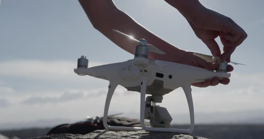 A person adjusts the rotor on a drone