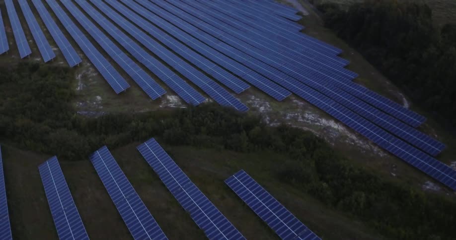 Solar panels sit in a field