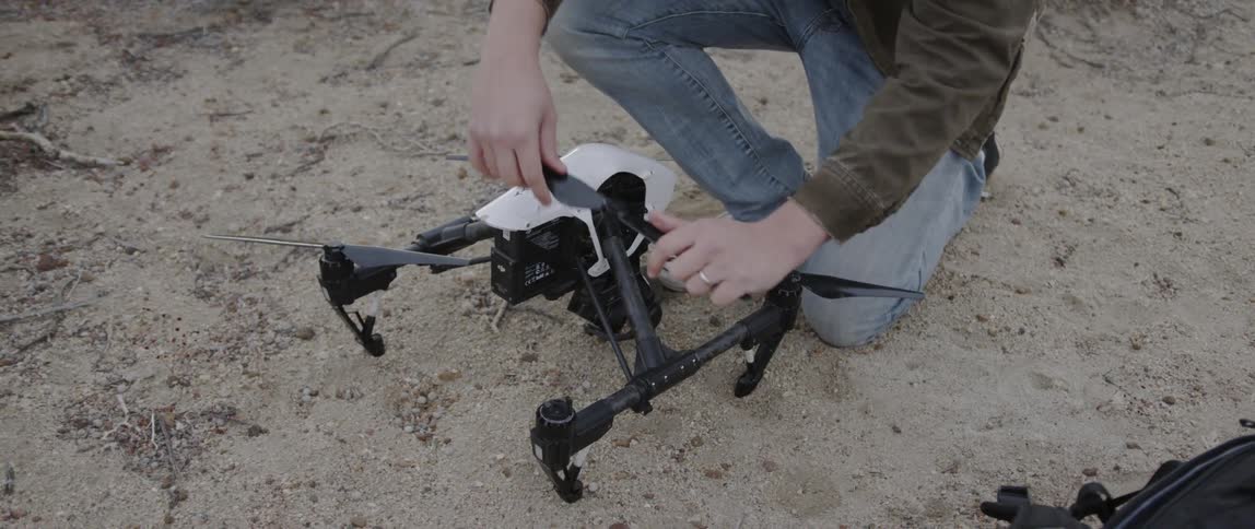 A man attaches a propeller on the drone